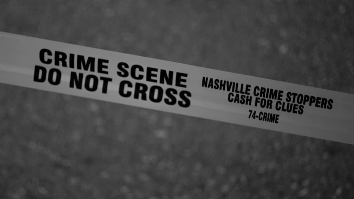 Black and white close-up of crime scene tape with Nashville text.
