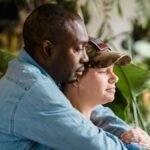 A soldier and partner share a loving embrace indoors, symbolizing reunion and love.