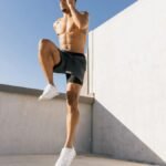 Male athlete doing cardio workout on a rooftop under blue sky in Austin, Texas.