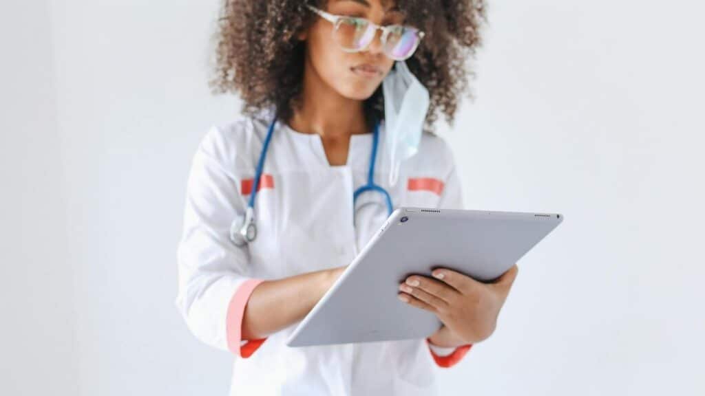 A female doctor using a digital tablet, symbolizing modern healthcare and technology integration.