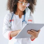 A female doctor using a digital tablet, symbolizing modern healthcare and technology integration.