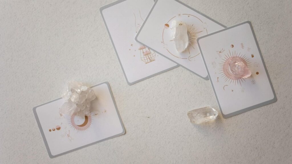 Mystical tarot cards paired with healing crystals on a serene surface, embracing spirituality.