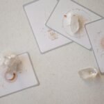 Mystical tarot cards paired with healing crystals on a serene surface, embracing spirituality.
