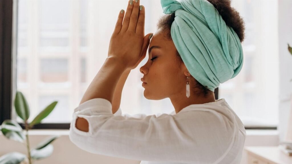Woman practicing meditation indoors with a focus on relaxation and mindfulness.