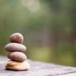 Balance and tranquility embodied by stacked stones in a natural outdoor setting.