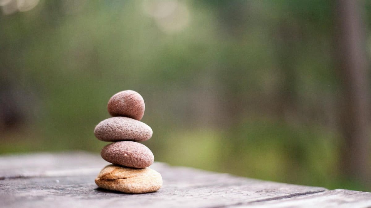Balance and tranquility embodied by stacked stones in a natural outdoor setting.