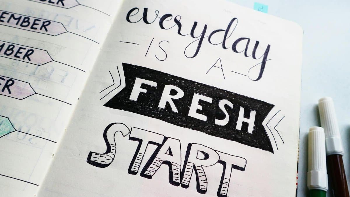 Notebook page featuring motivational quote 'Everyday is a fresh start' with colorful pens.