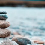 Close-up of stacked stones on a riverbank in Batabari, India, exhibiting balance and tranquility.