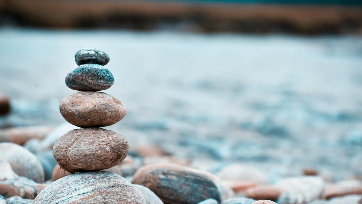 Close-up of stacked stones on a riverbank in Batabari, India, exhibiting balance and tranquility.