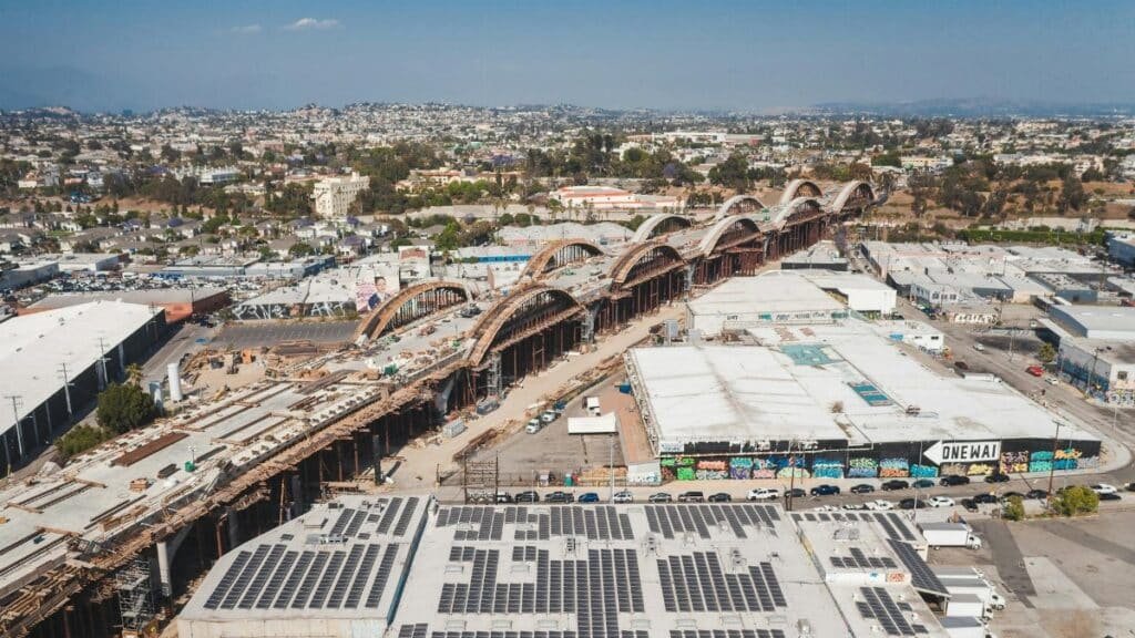 Explore this aerial view of solar panels and construction amidst the urban landscape of Los Angeles.