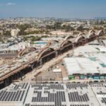Explore this aerial view of solar panels and construction amidst the urban landscape of Los Angeles.