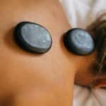 Peaceful spa setting with hot stone therapy promoting relaxation and relief.