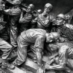 Detailed relief showing a group of miners in action, capturing the essence of teamwork and labor.