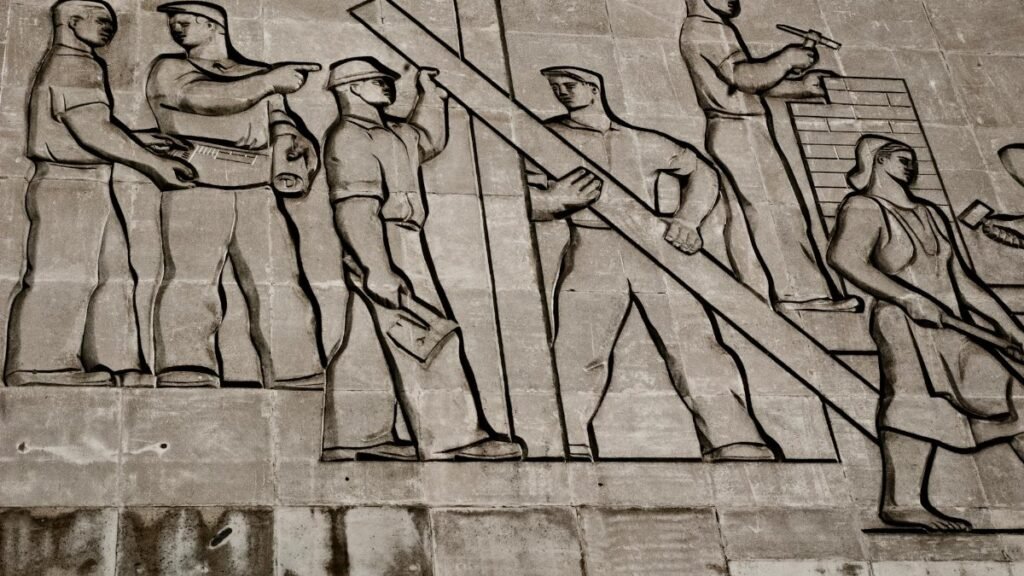 A detailed view of a Soviet-era relief sculpture depicting workers in Budapest, Hungary.