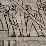 A detailed view of a Soviet-era relief sculpture depicting workers in Budapest, Hungary.