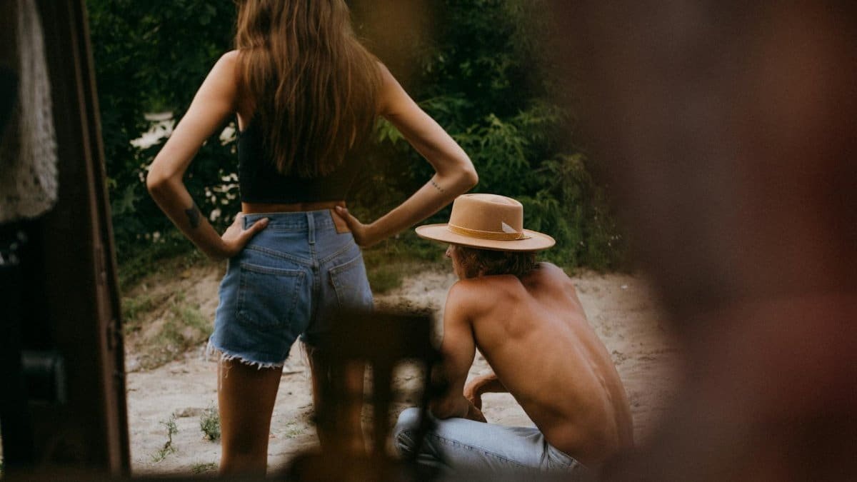 Two people enjoy a relaxing summer day outdoors, captured in a candid moment.