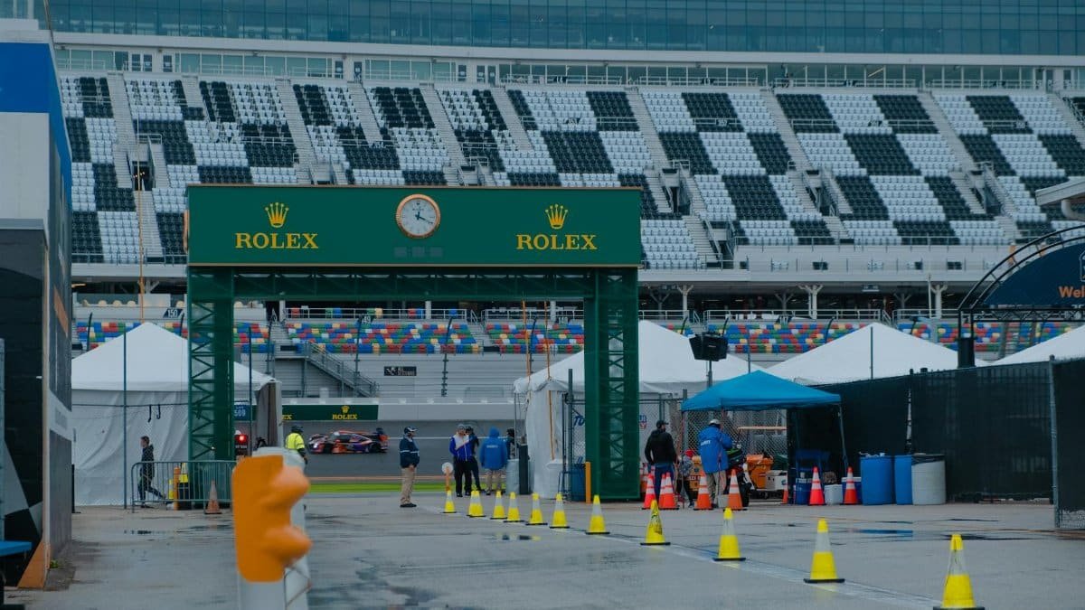 Exciting scene at Daytona Speedway with Rolex sponsorship during a race event.