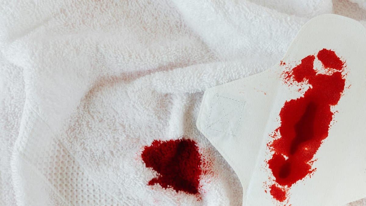 Detailed view of a menstrual pad and stained towel symbolizing menstruation awareness.