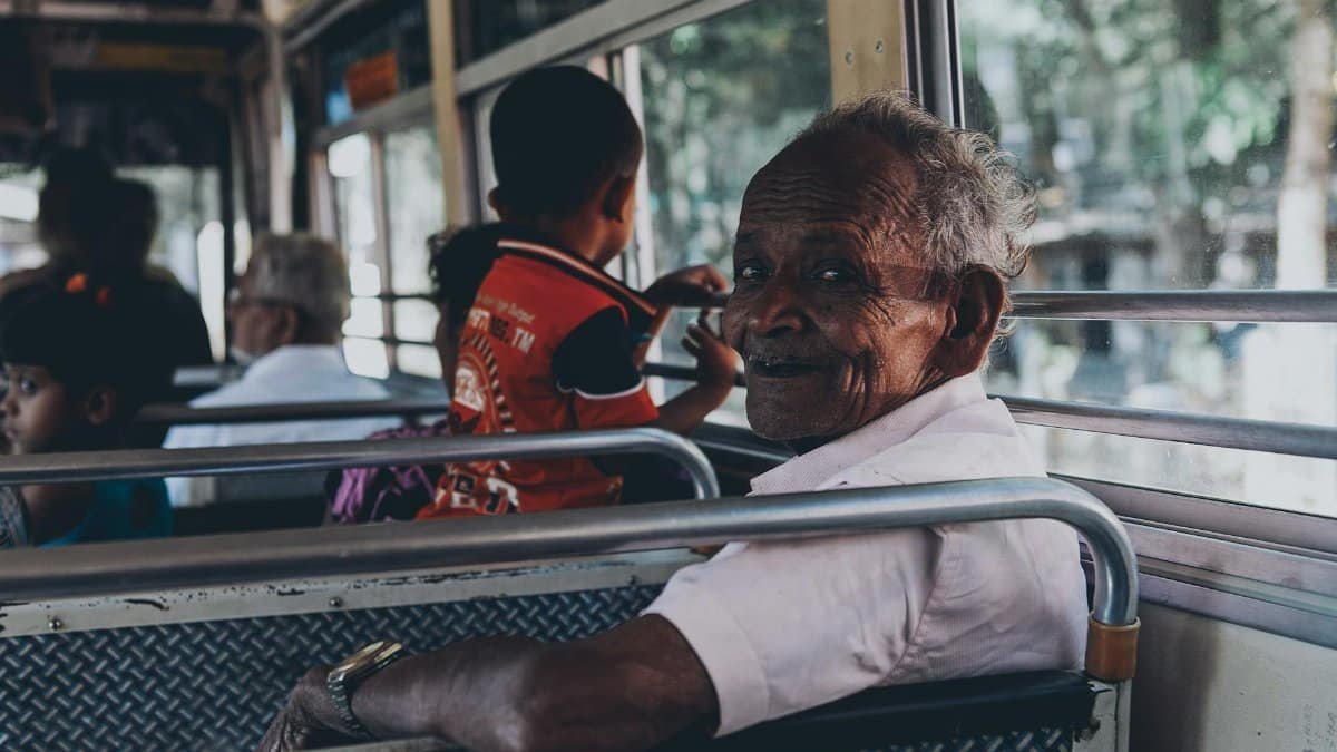 A candid scene of diverse passengers riding a public bus in Sri Lanka, capturing everyday travel.