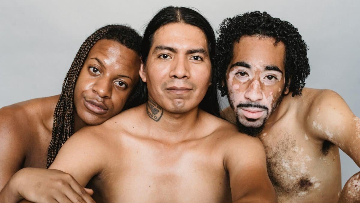 Portrait of three diverse men embodying acceptance and body positivity in a studio setting.