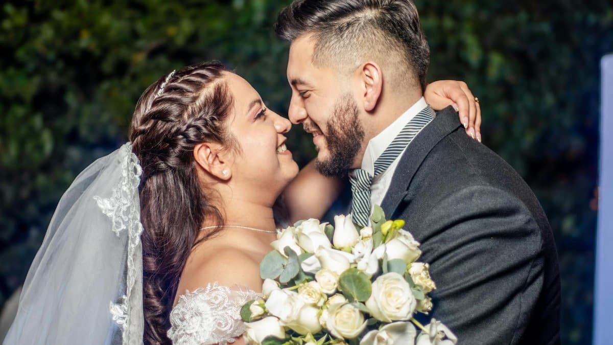 Joyful couple sharing a romantic moment at their wedding in México, embracing with love and happiness.