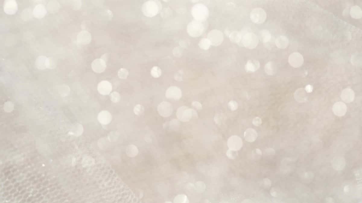 Soft focus white bokeh lights creating a magical, shimmering abstract background.