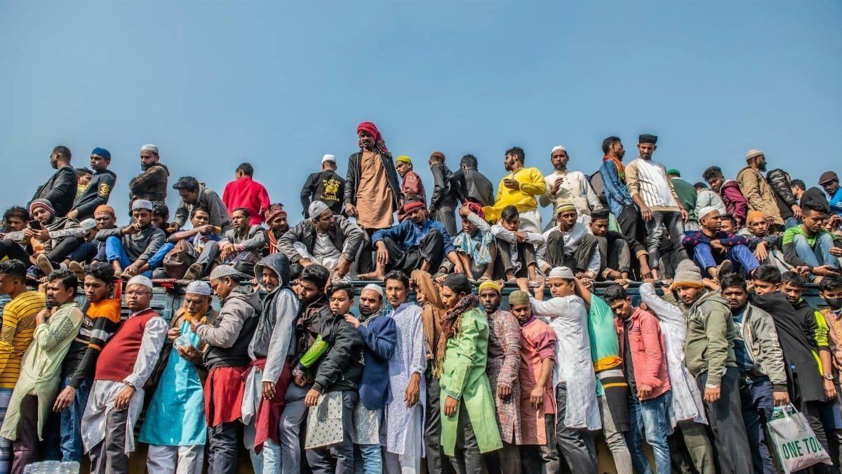 A vibrant and colorful gathering of people crowding a train roof during a festival in Bangladesh.