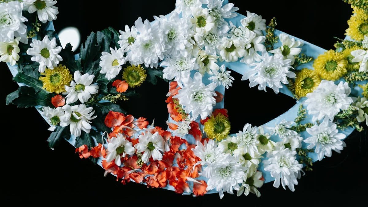 A vibrant peace symbol made of colorful flowers, capturing a serene and peaceful message.