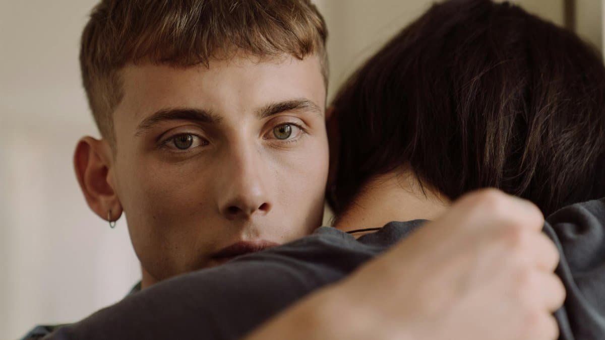 A close-up of a young couple embracing, capturing intimate emotions and connection.