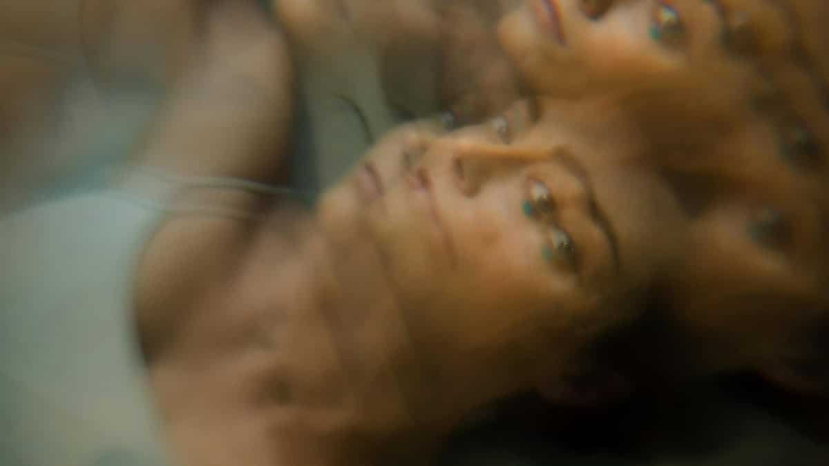 Dreamlike portrait of a woman with multiple overlapping exposures creating an abstract effect.
