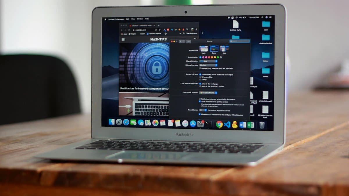 Open MacBook Air with apps and web browser on screen, placed on a wooden table indoors.