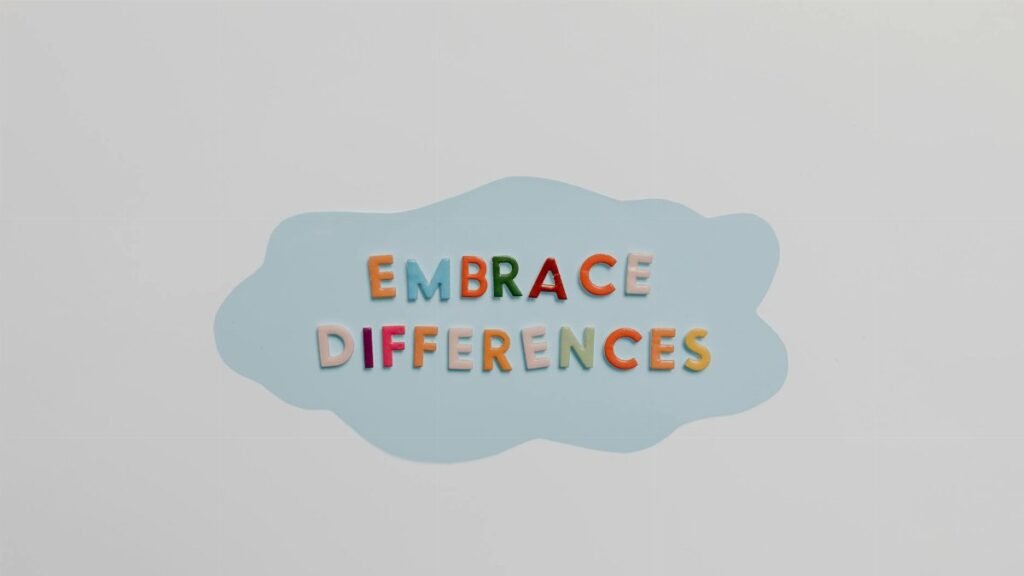Colorful letters spelling 'Embrace Differences' on a blue cloud shape symbolizing acceptance and diversity.