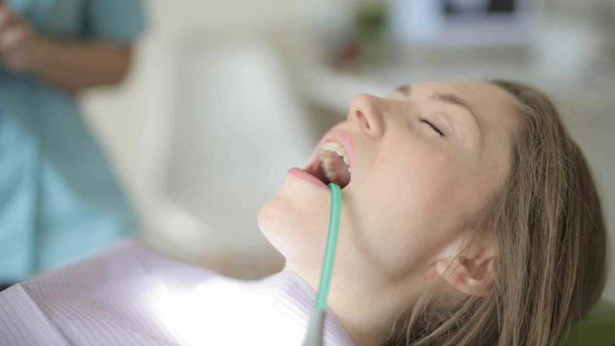 A young woman undergoing a dental checkup, showcasing healthcare and oral hygiene.