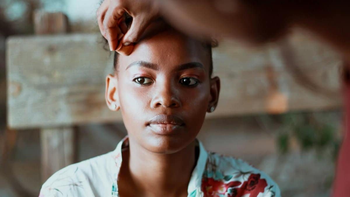 Portrait of a young woman having a beauty treatment outside. Natural lighting enhances her serene expression.