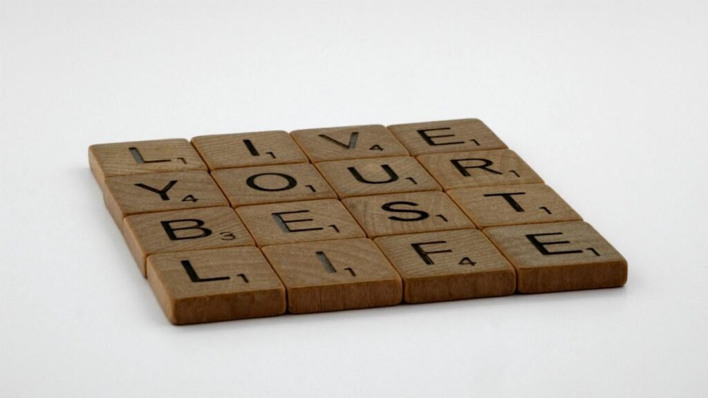 Scrabble tiles spelling 'Live Your Best Life' on a white background.