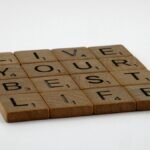 Scrabble tiles spelling 'Live Your Best Life' on a white background.