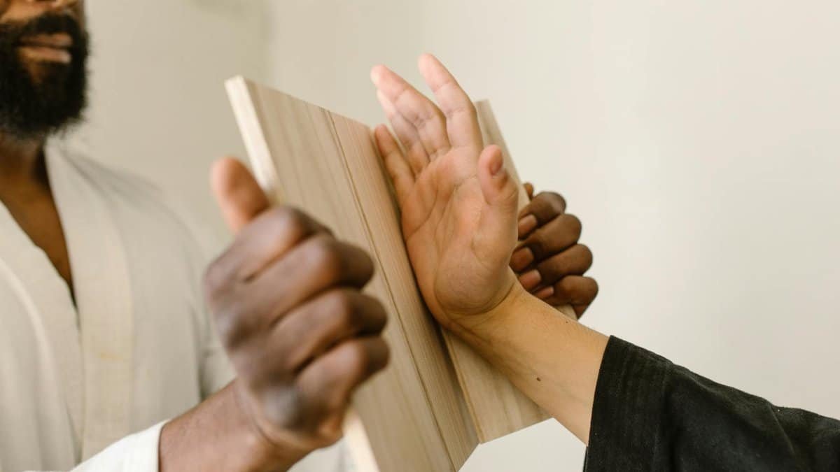 Close-up of martial arts board breaking, showcasing technique focused practice.