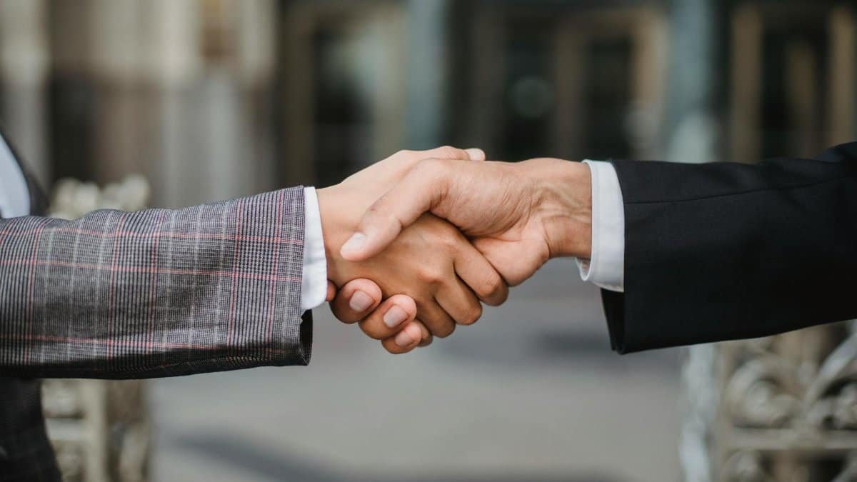 A close-up of two businesspeople shaking hands, symbolizing cooperation and partnership.