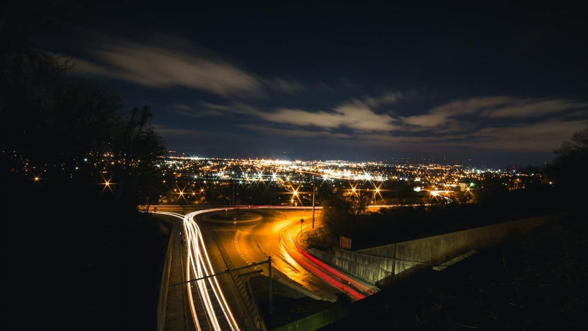 Long exposure of Chattanooga highway at night showcasing light trails and city lights.