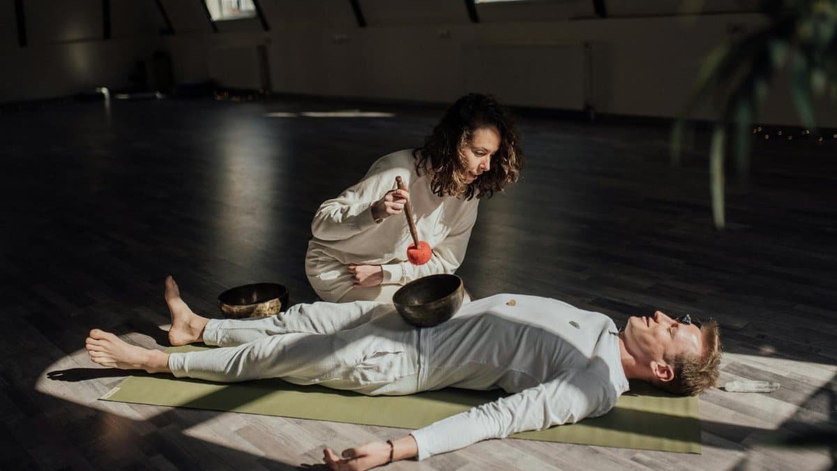 A soothing indoor sound bath session with Tibetan singing bowls promoting relaxation and healing.
