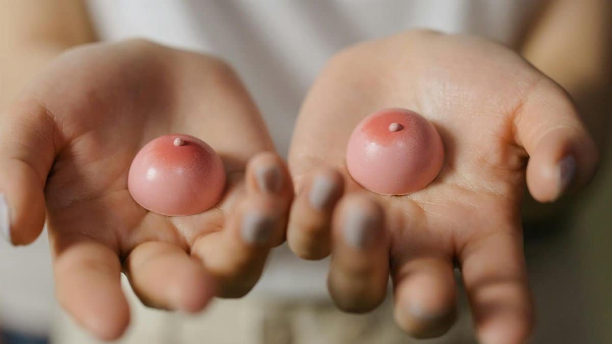 Close-up of hands holding pink silicone sensory toys focusing on wellness and self-care.