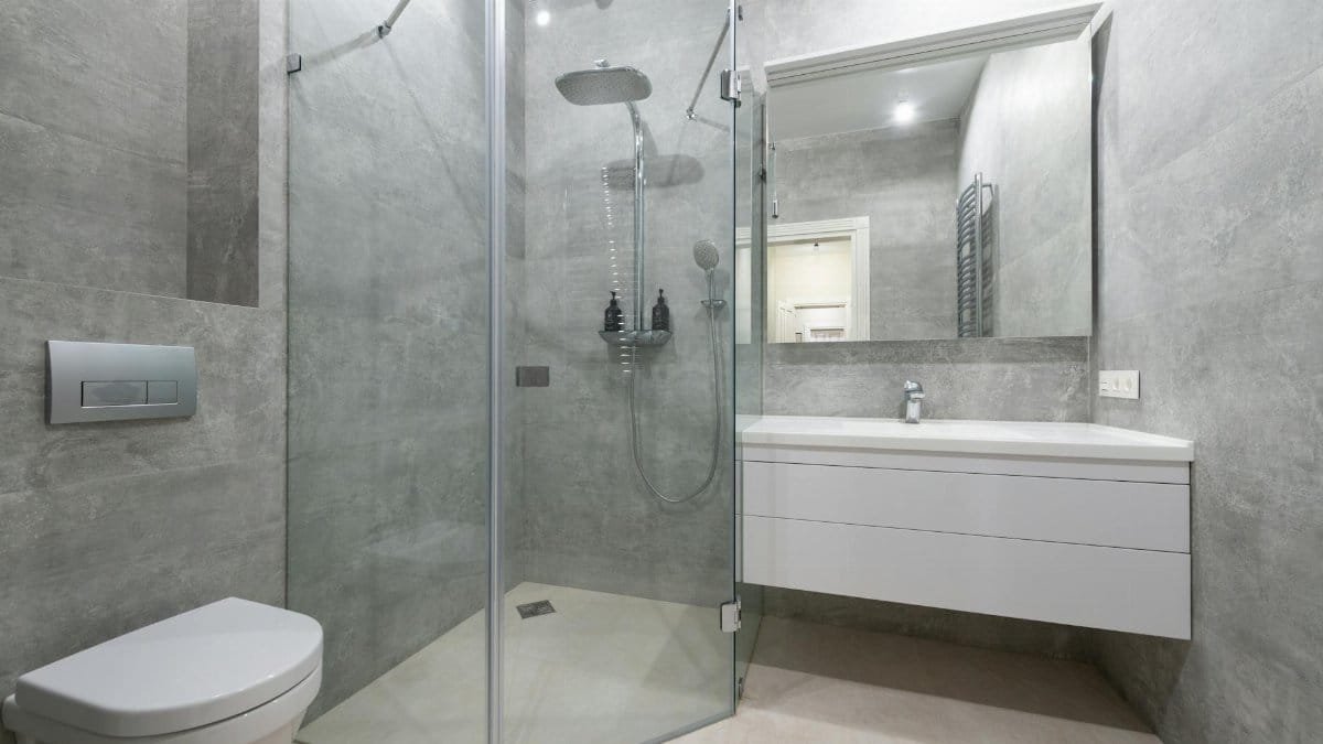 Elegant modern bathroom with glass shower and sleek fixtures.