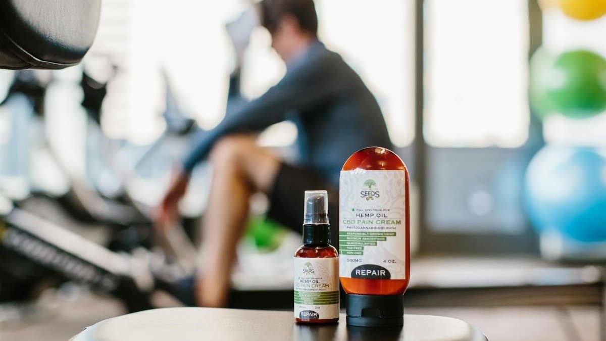 Close-up of hemp oil products in a gym focus on wellness and recovery.