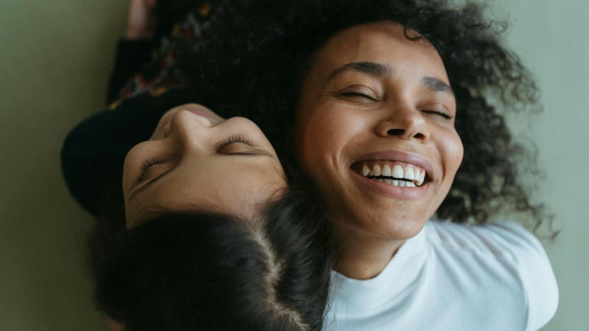 Happy mother and daughter sharing a joyful embrace, exuding warmth and love.