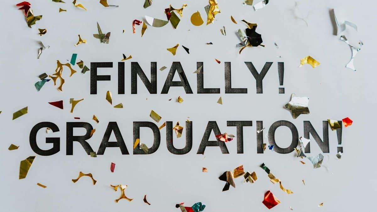 Colorful confetti surrounds 'FINALLY! GRADUATION!' signifying celebration and achievement.