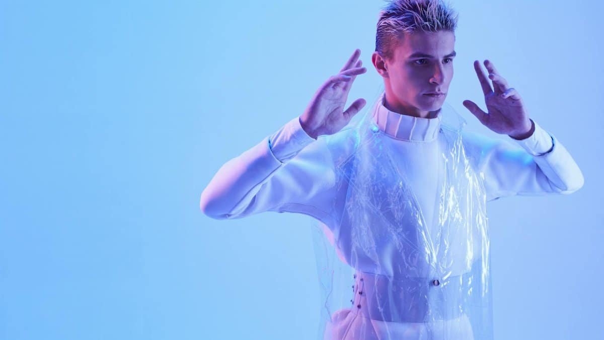 Futuristic portrait of a man in a studio with blue lighting, exuding cybernetic vibes.