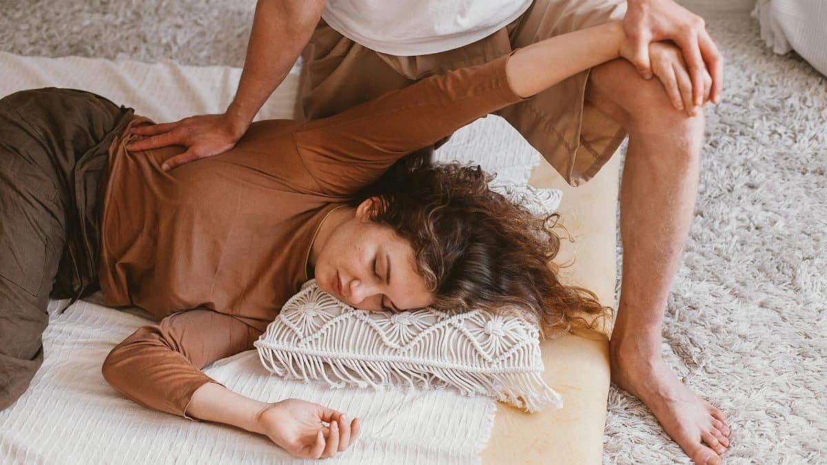 Relaxing indoor massage session capturing warmth and comfort with a focus on therapeutic techniques.