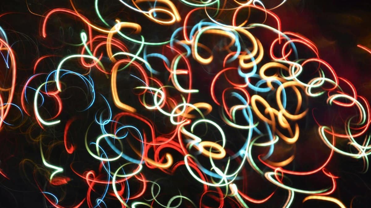 Colorful abstract light trails creating vibrant patterns against a dark background.