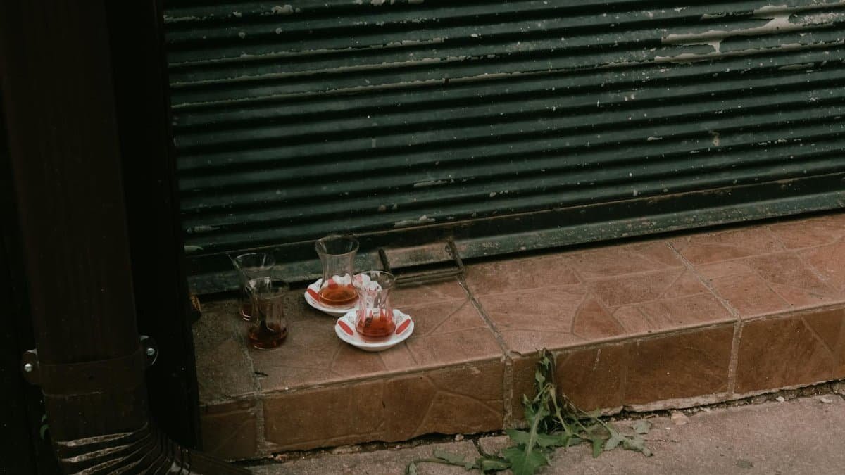 Empty tea glasses left on a step, capturing an urban street vibe.