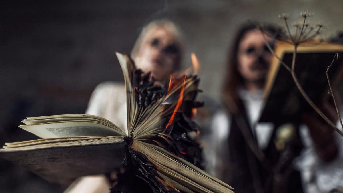 Close-up of an open book being burned, creating a dramatic and intense atmosphere.
